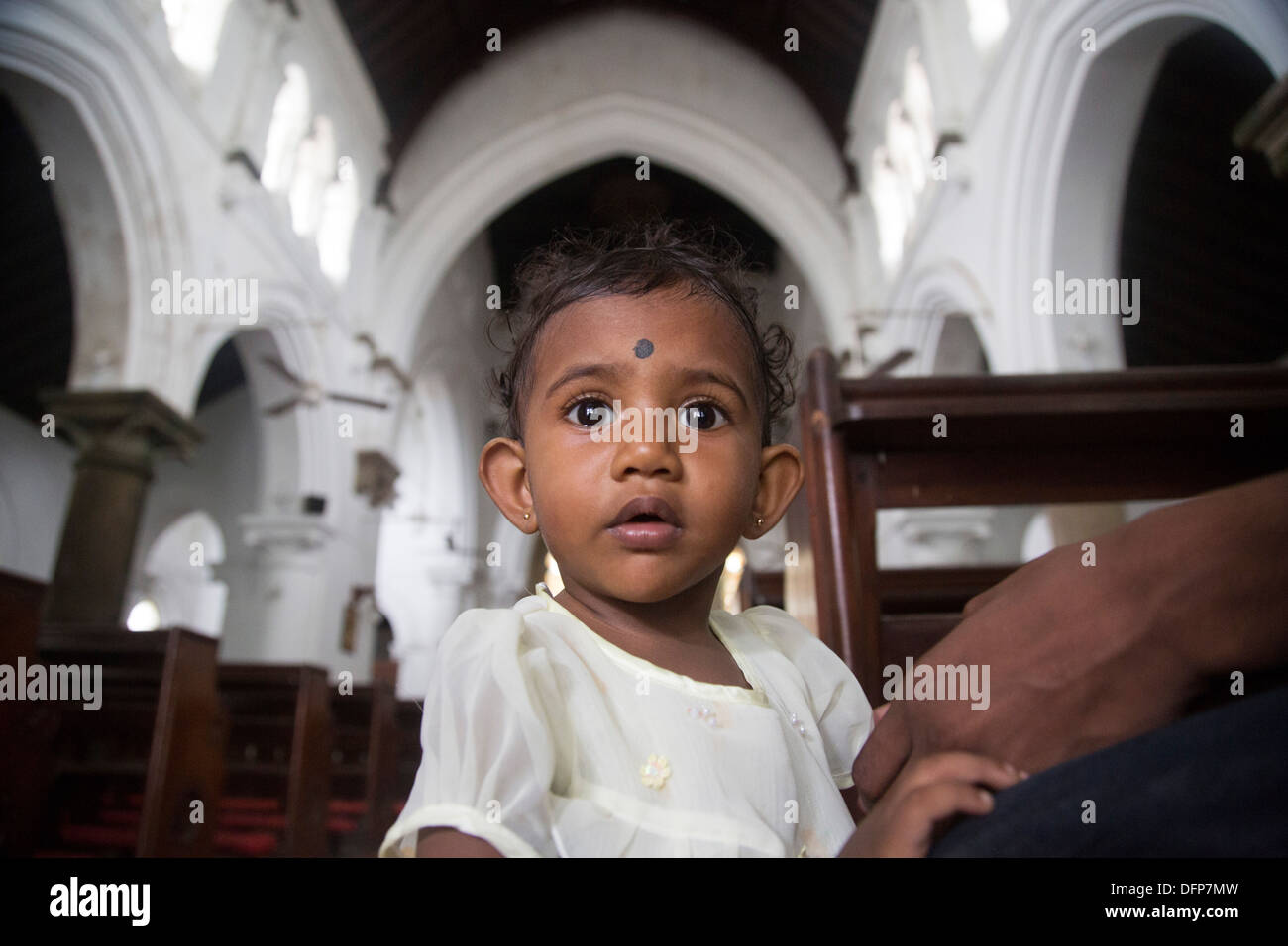 young girl bookies in church pink shoes Stock Photo