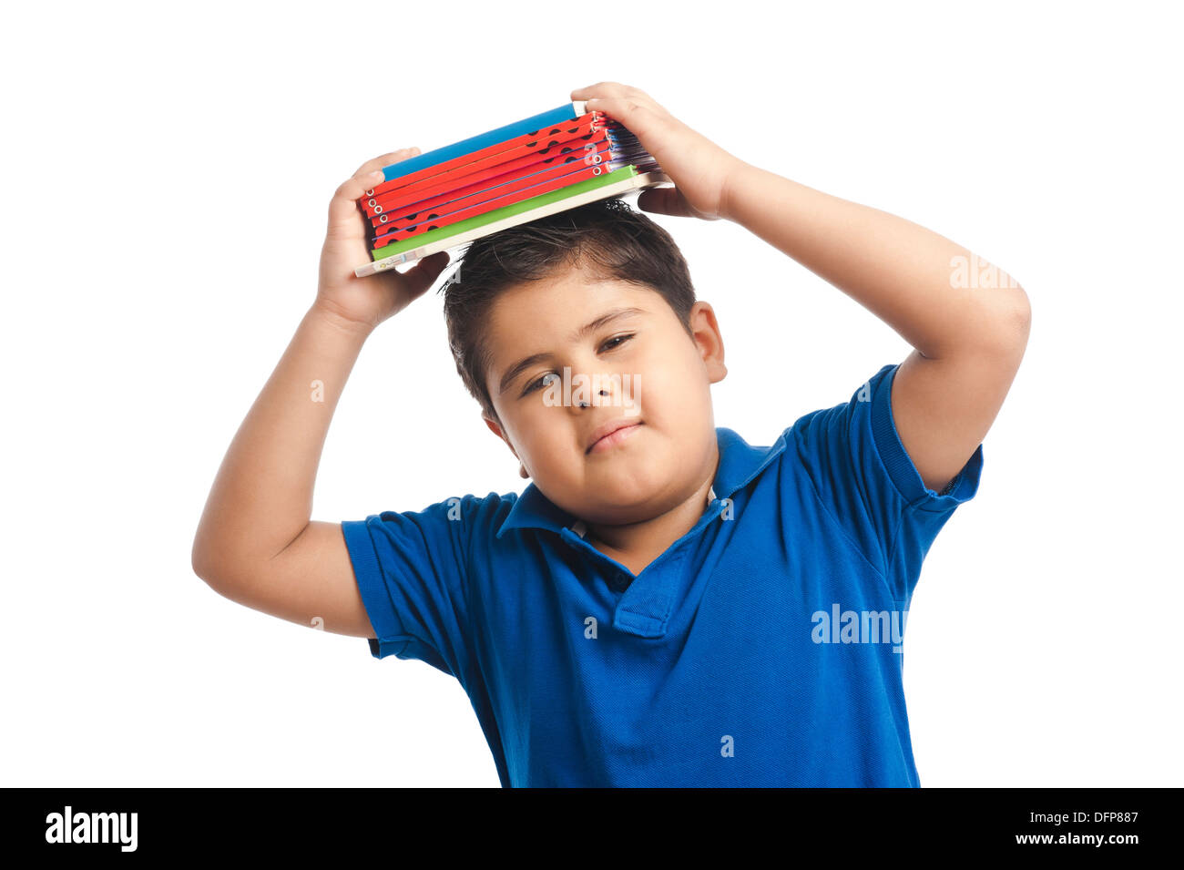 Boy holding a stack of books over his head Stock Photo
