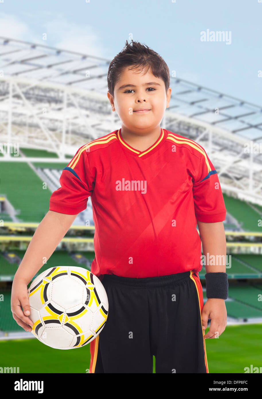 Boy carrying a soccer ball Stock Photo