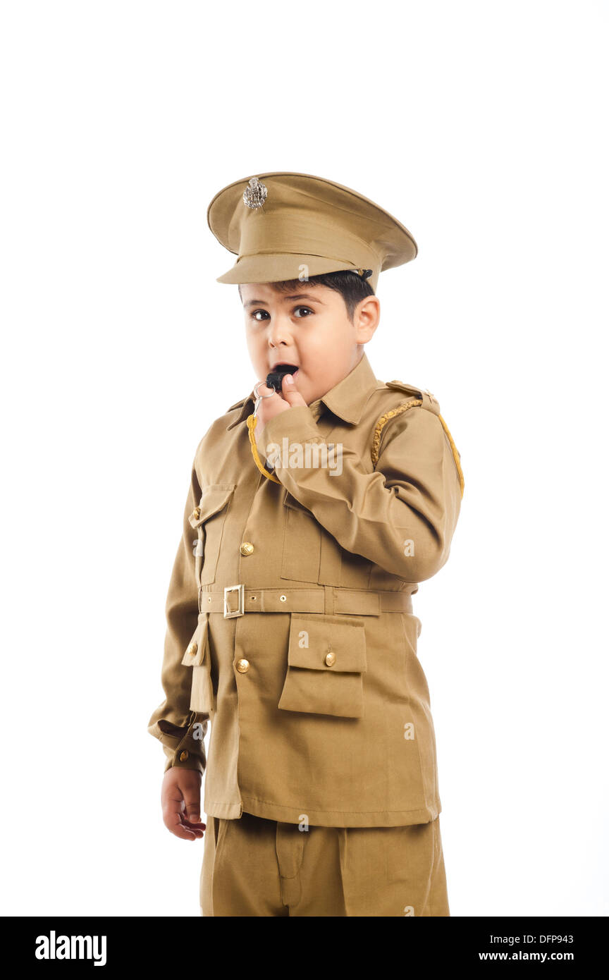 Close-up of a boy dressed as a police uniform blowing a whistle Stock Photo