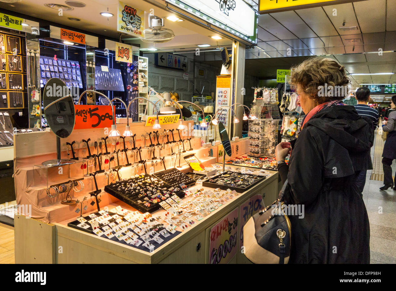 European woman browsing in fashion accessory shop in Jamsil Station Underground Shopping Centre