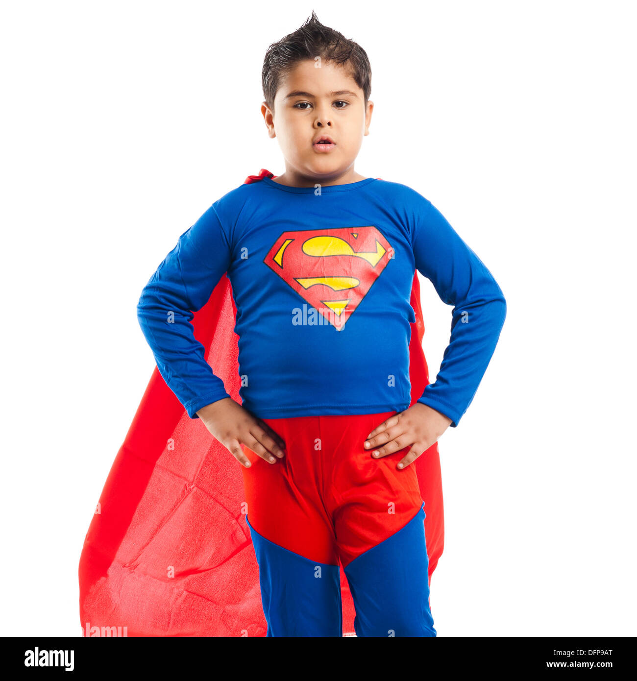 Boy dressed as a superman standing with his arm akimbo Stock Photo