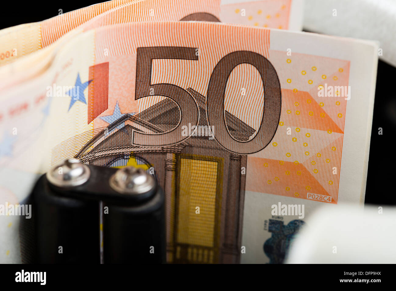 Fifty Euro notes being counted in a machine Stock Photo