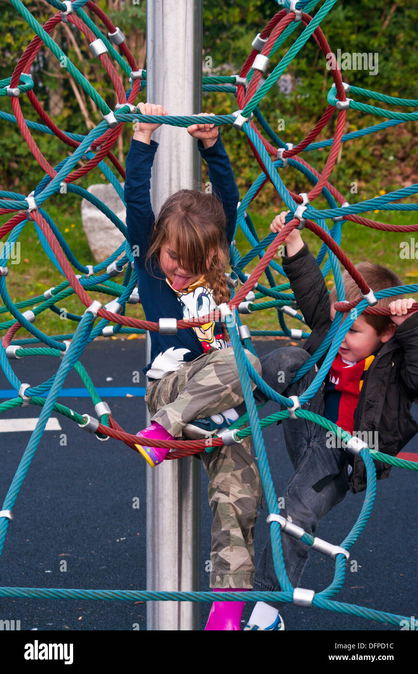 Children playing on a rope climbing frame Stock Photo