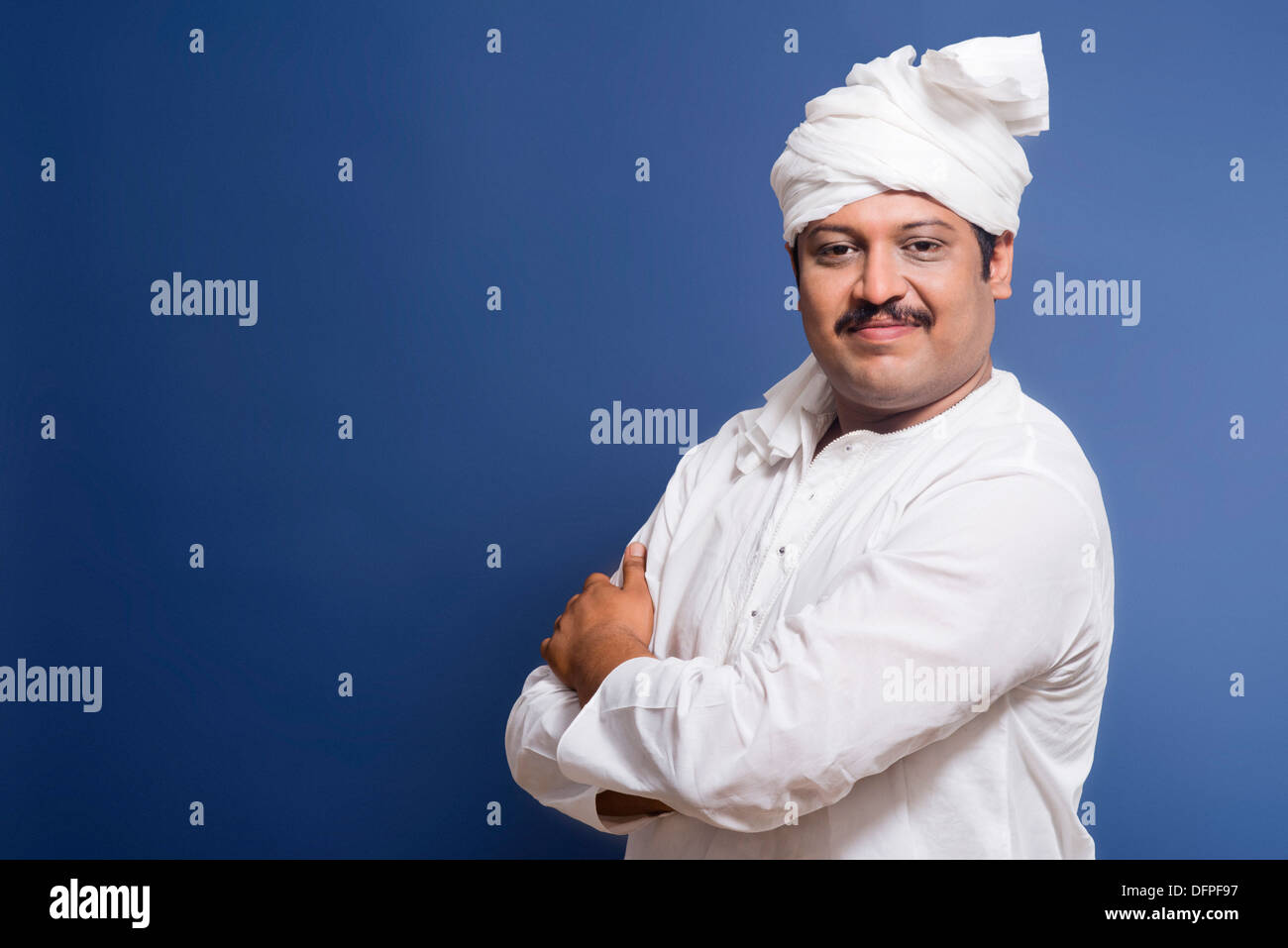 Portrait of a man standing with his arms crossed and smiling Stock ...