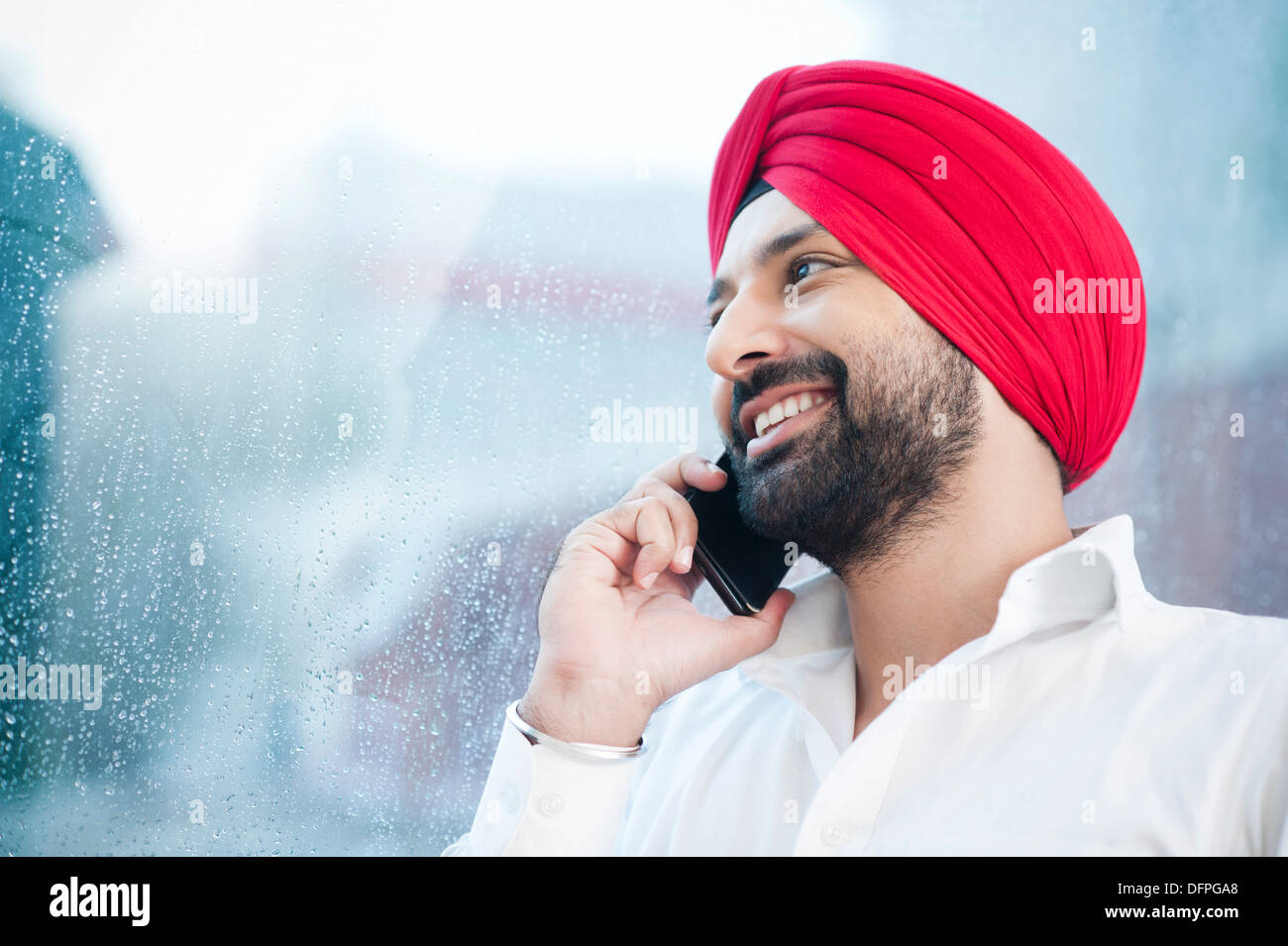 Close-up of a Sikh man talking on a mobile phone Stock Photo