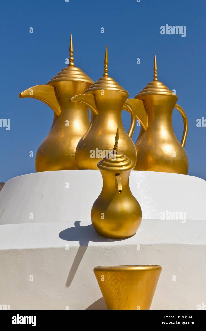 Decorative gold coffee urns at a roundabout in Muscat, Oman Stock Photo Alamy