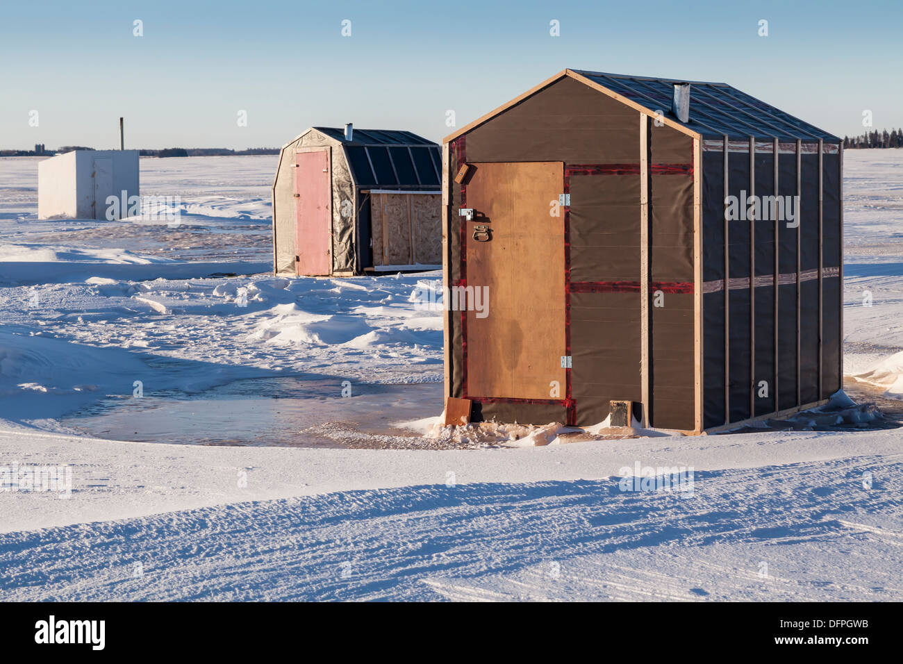 Rustic ice fishing shacks out on the ice Stock Photo Alamy