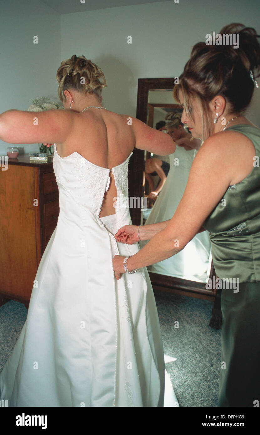 Bride getting dressed. Stock Photo