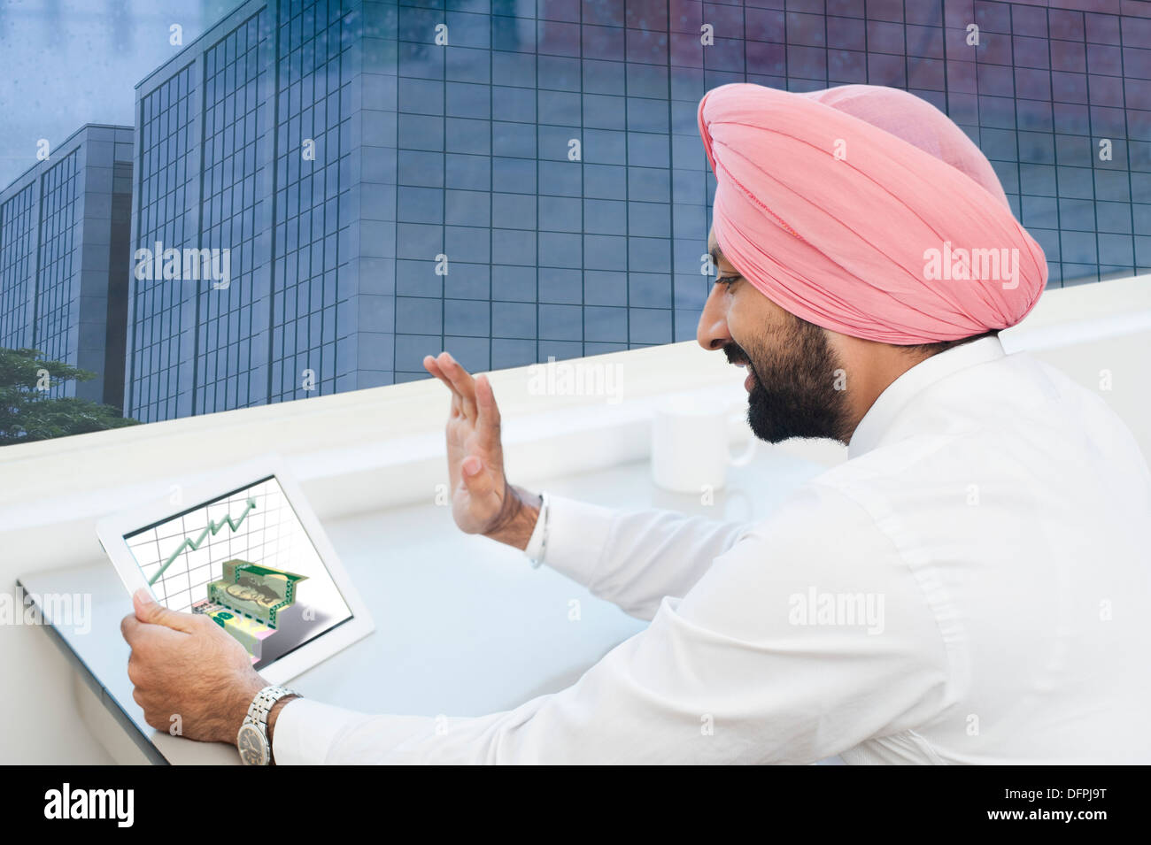 Businessman analyzing graph on a digital tablet Stock Photo
