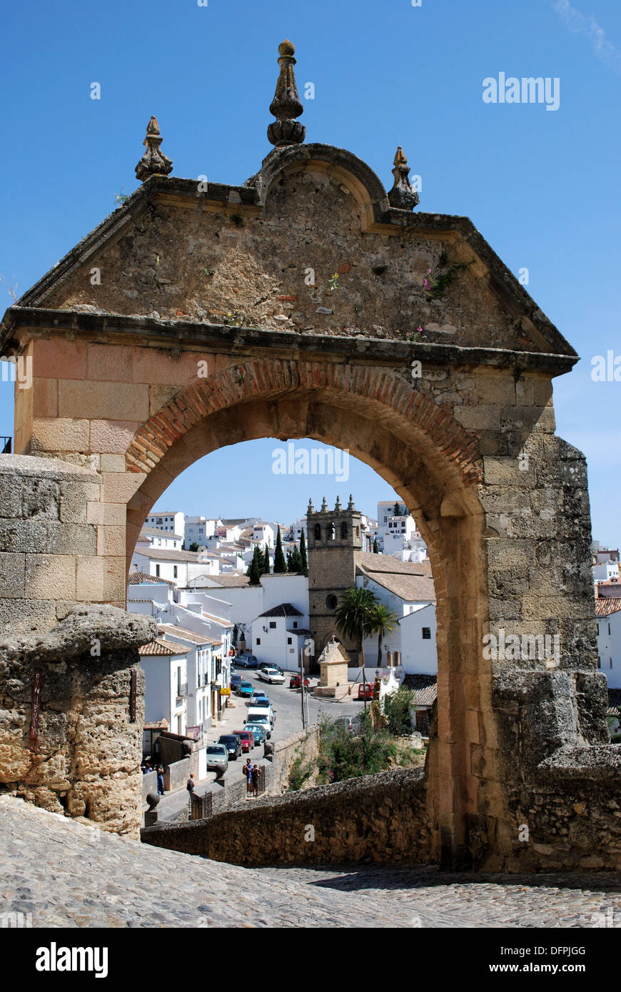 View through the Phillip V arch along the old bridge (Puente Viejo) arch towards the old town, Ronda, Andalusia, Western Europe Stock Photo