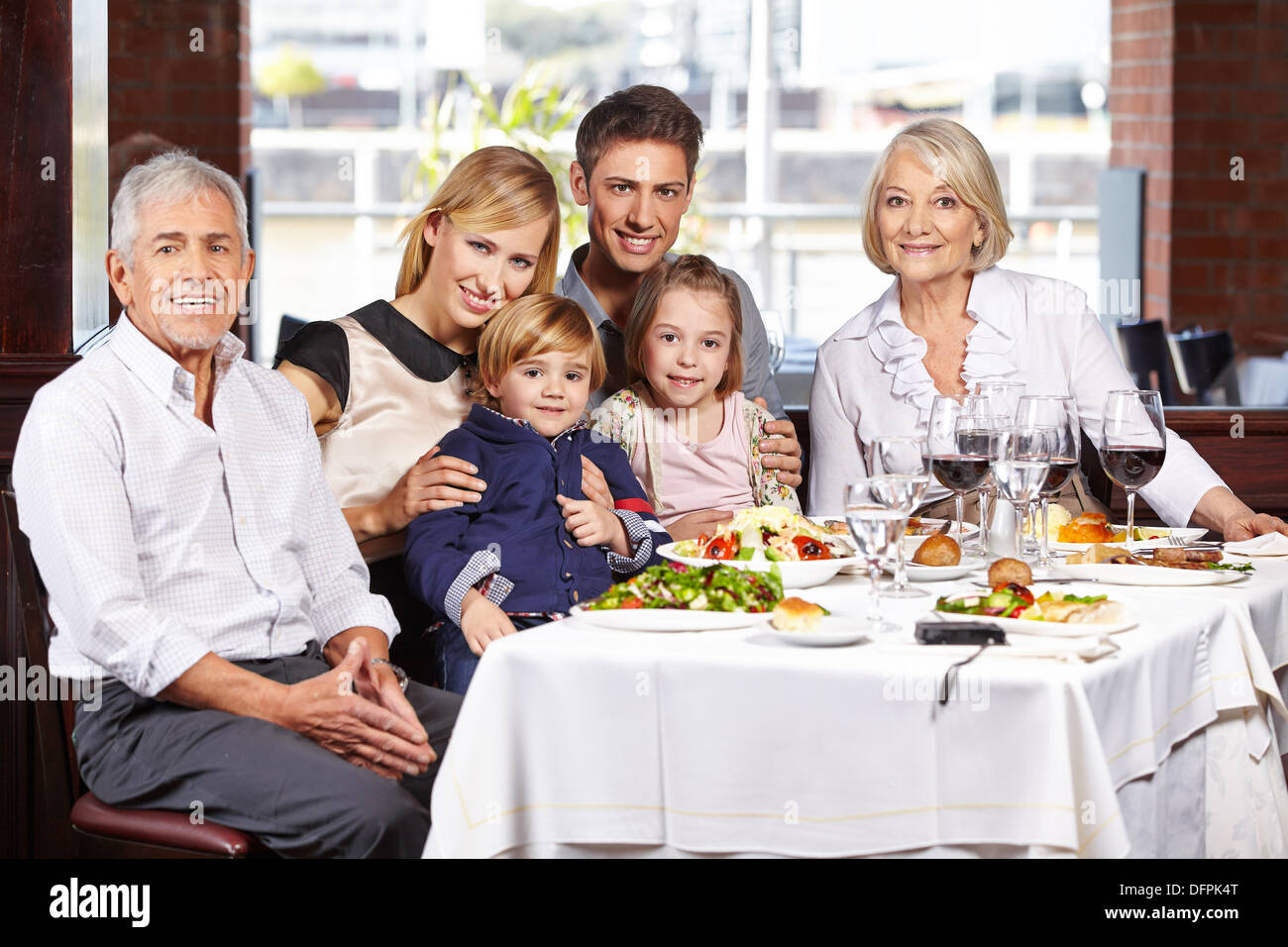 Portrait of a happy family with children and grandparents at the dining table Stock Photo