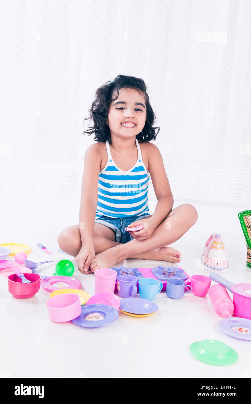 Portrait of a girl playing with toys and smiling Stock Photo - Alamy