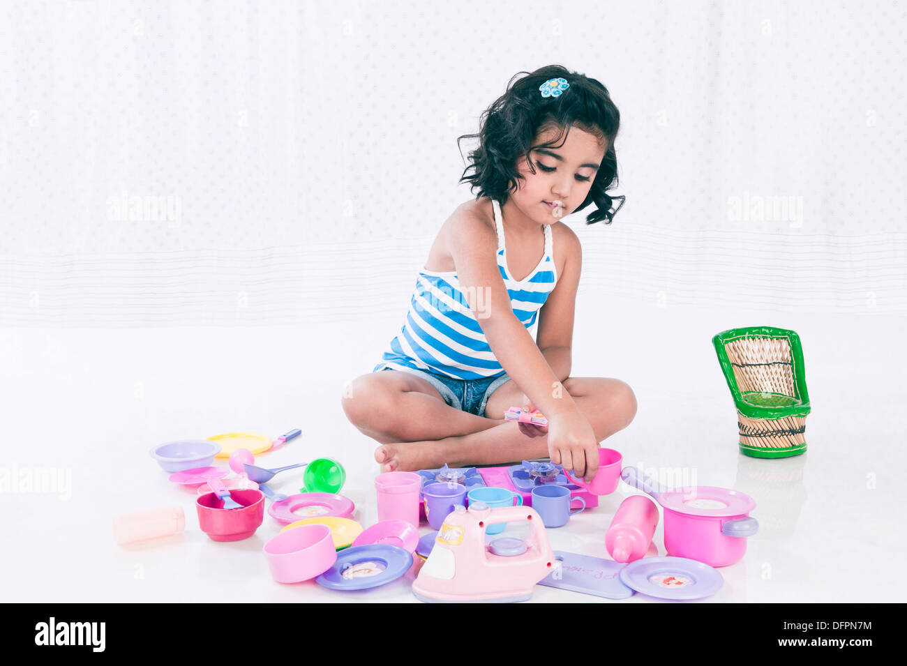 Girl playing with toys Stock Photo - Alamy