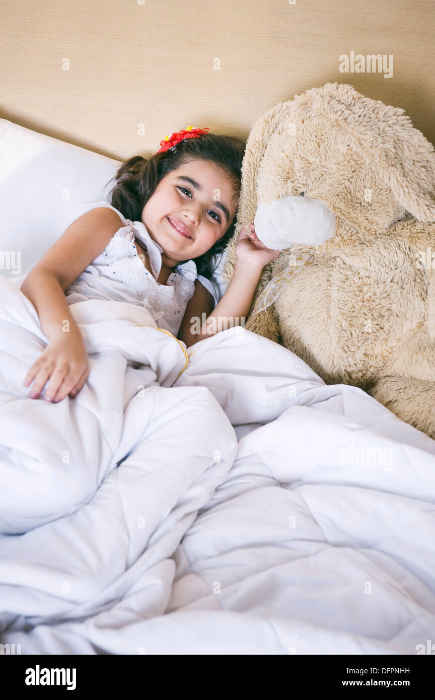 Girl lying on the bed and smiling Stock Photo - Alamy
