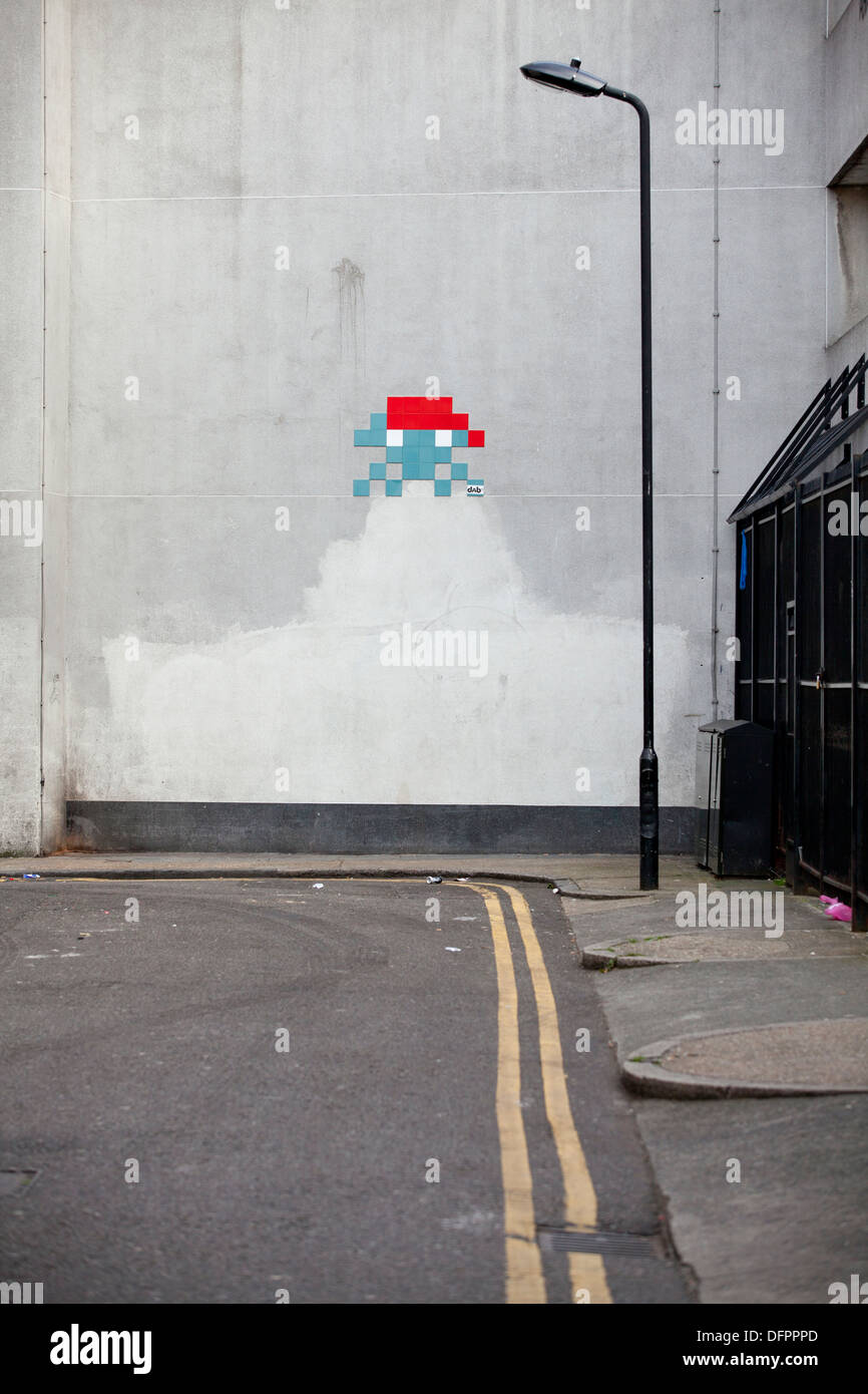 Space Invader graffiti, created using a mosaic of tiles, Oxford Street, London Stock Photo