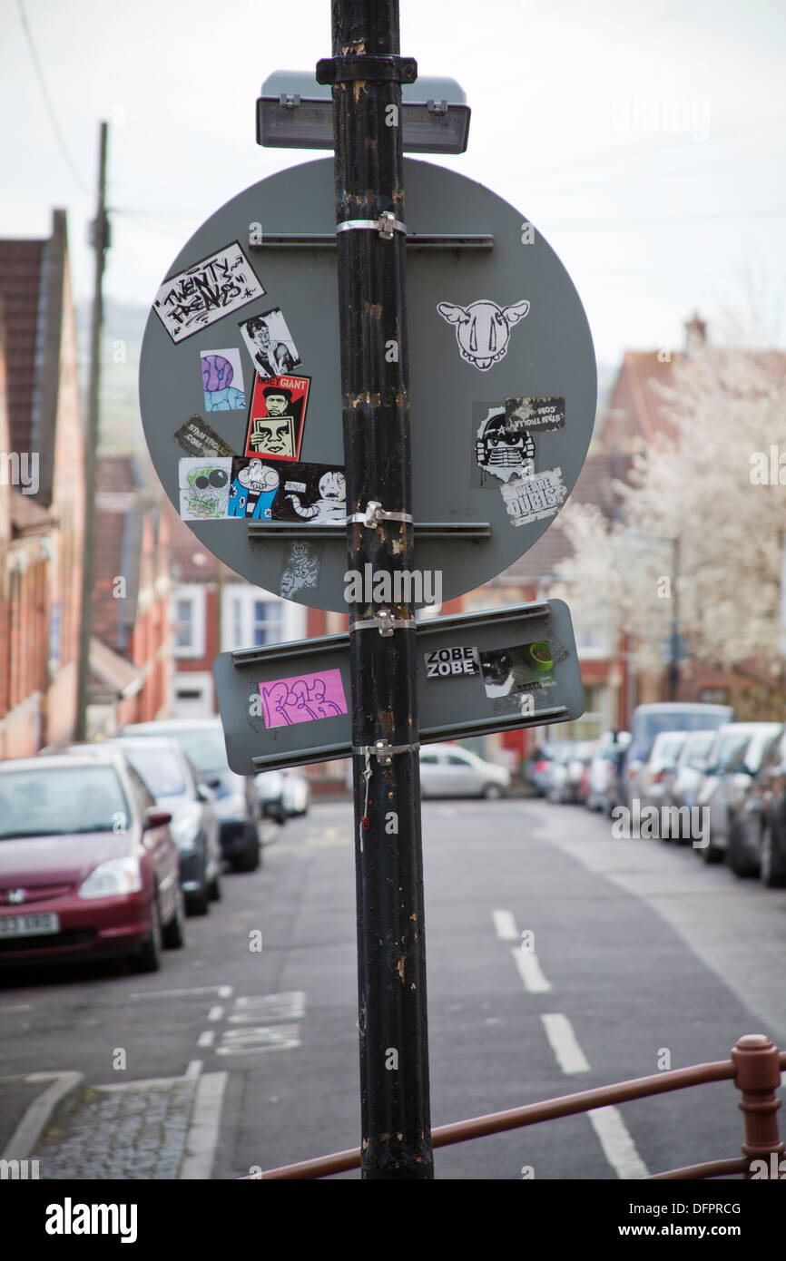 Graffiti stickers on back of signpost, Bristol, UK Stock Photo