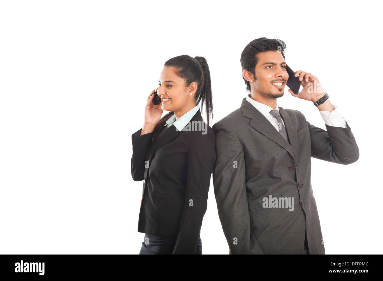 Business executives talking on mobile phones Stock Photo