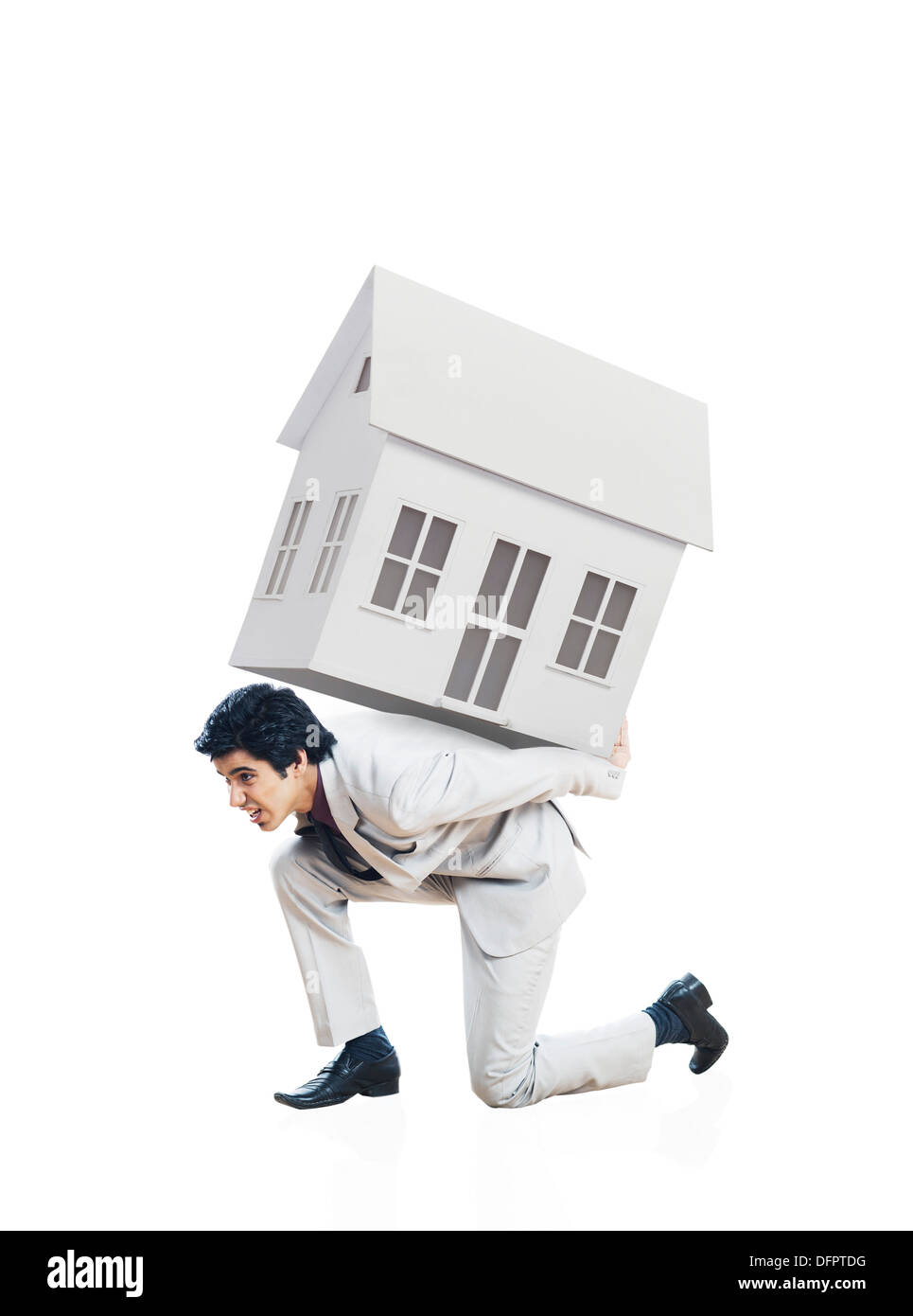 Businessman carrying a model home on his back Stock Photo