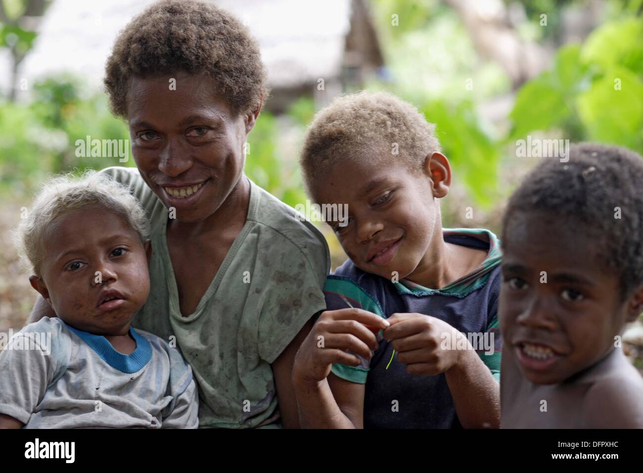 Shoulder and heads photograph of melanesian mother with her three kids ...