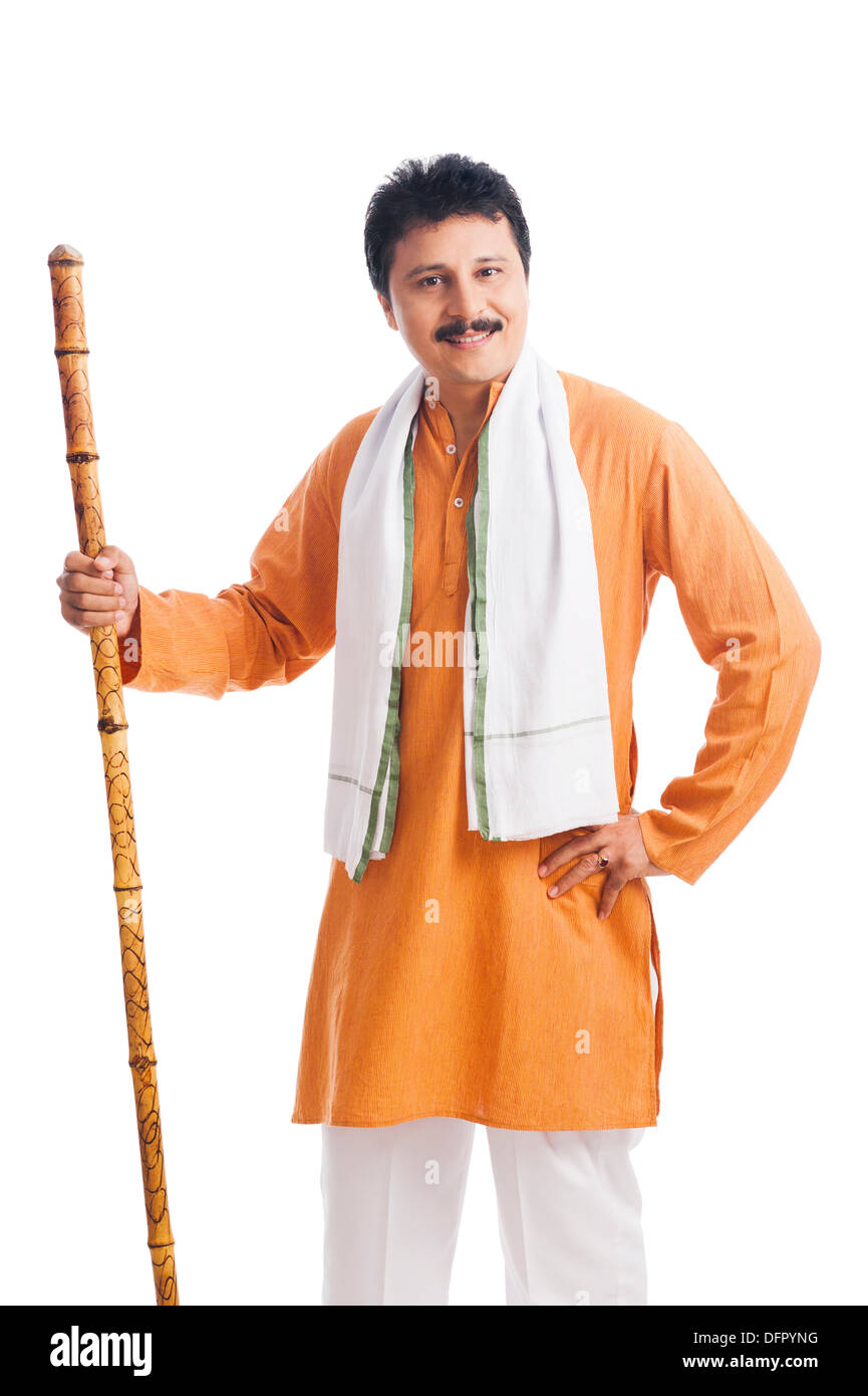 Portrait of a man holding wooden staff and smiling Stock Photo - Alamy