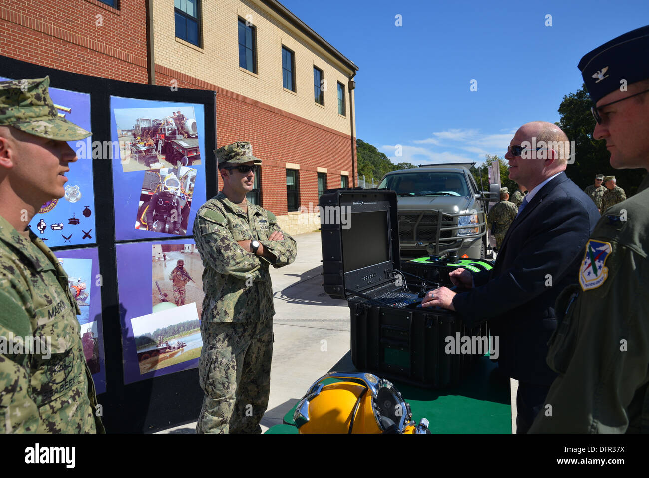 Deputy Assistant Secretary of Defense Reserve Affairs (DASD) Jason W. Forrester listens to a brief from sailors on the capabilities of the Underwater Construction Team 1 during a static display visit sponsored by Navy Expeditionary Combat Command held abo Stock Photo