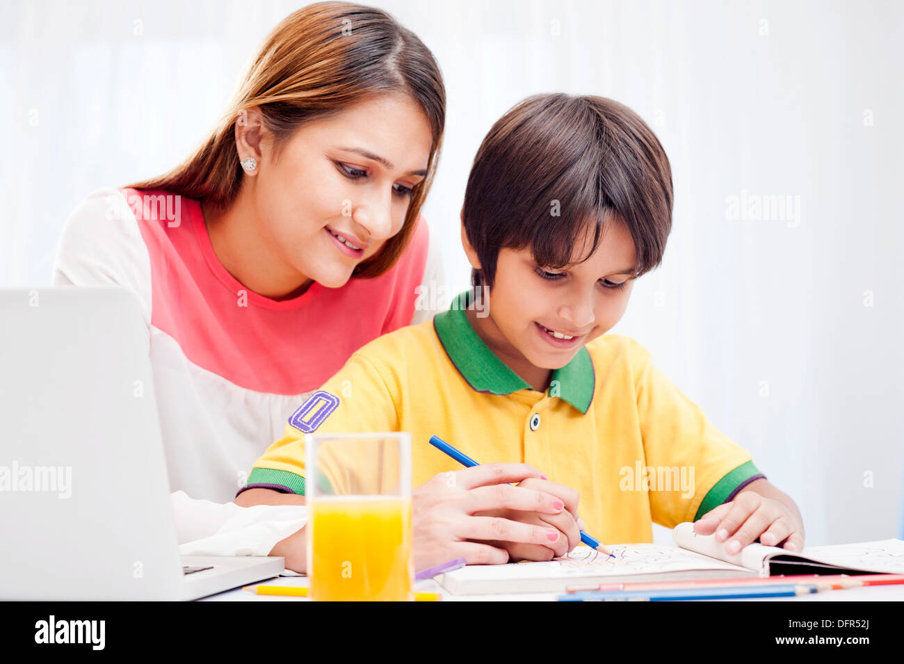 Woman assisting her son in drawing Stock Photo
