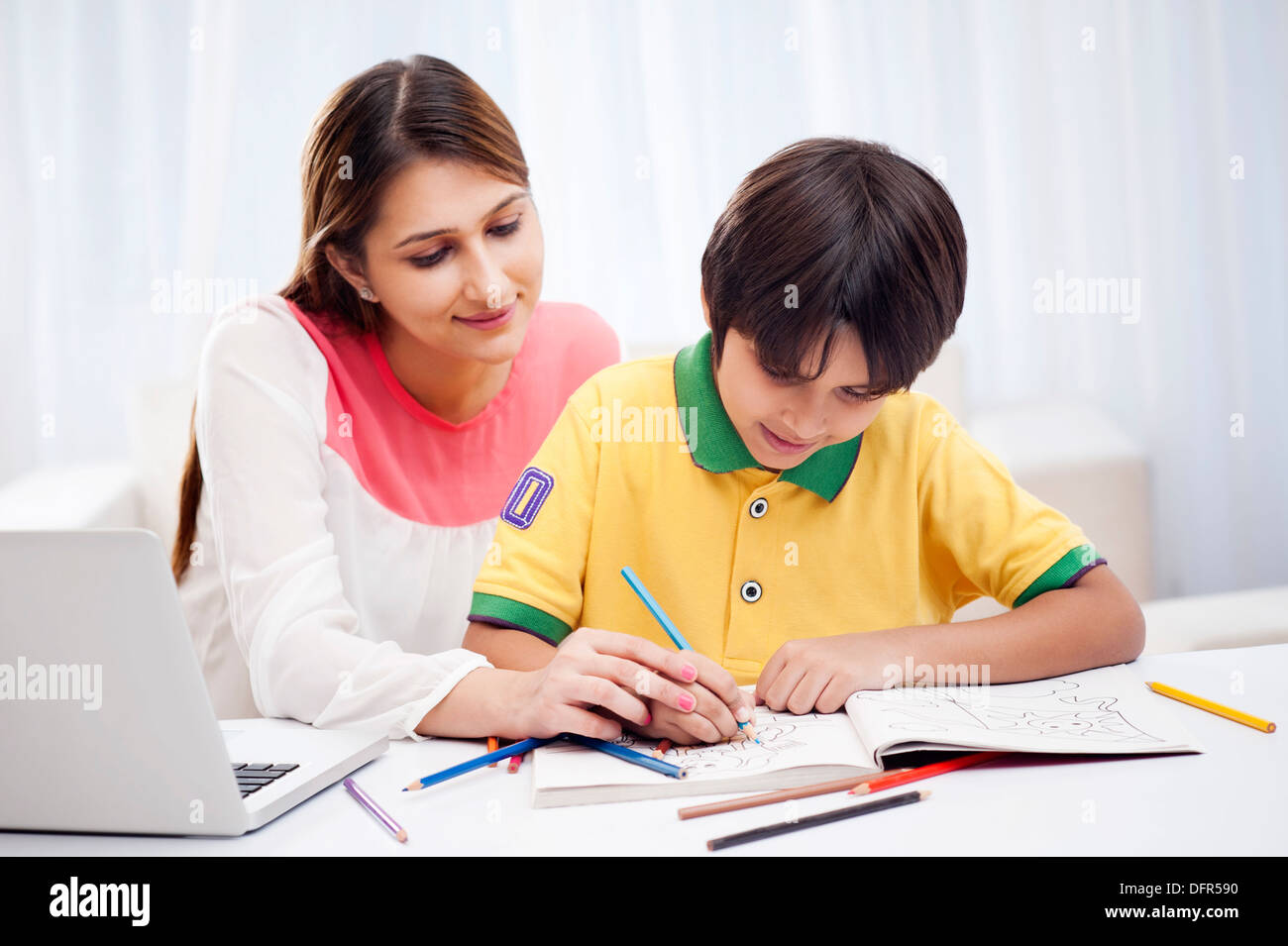 Woman assisting her son in drawing Stock Photo