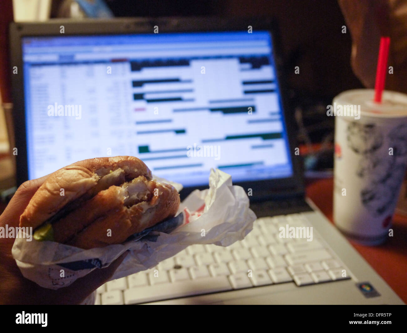 eating fast food working late night unhealthy Stock Photo