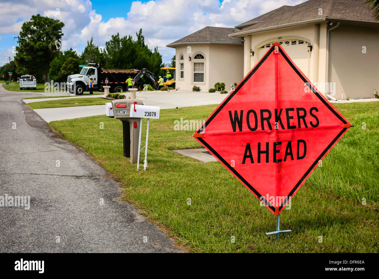 Large Diamond shaped sign alerting people that Workers are ahead Stock Photo