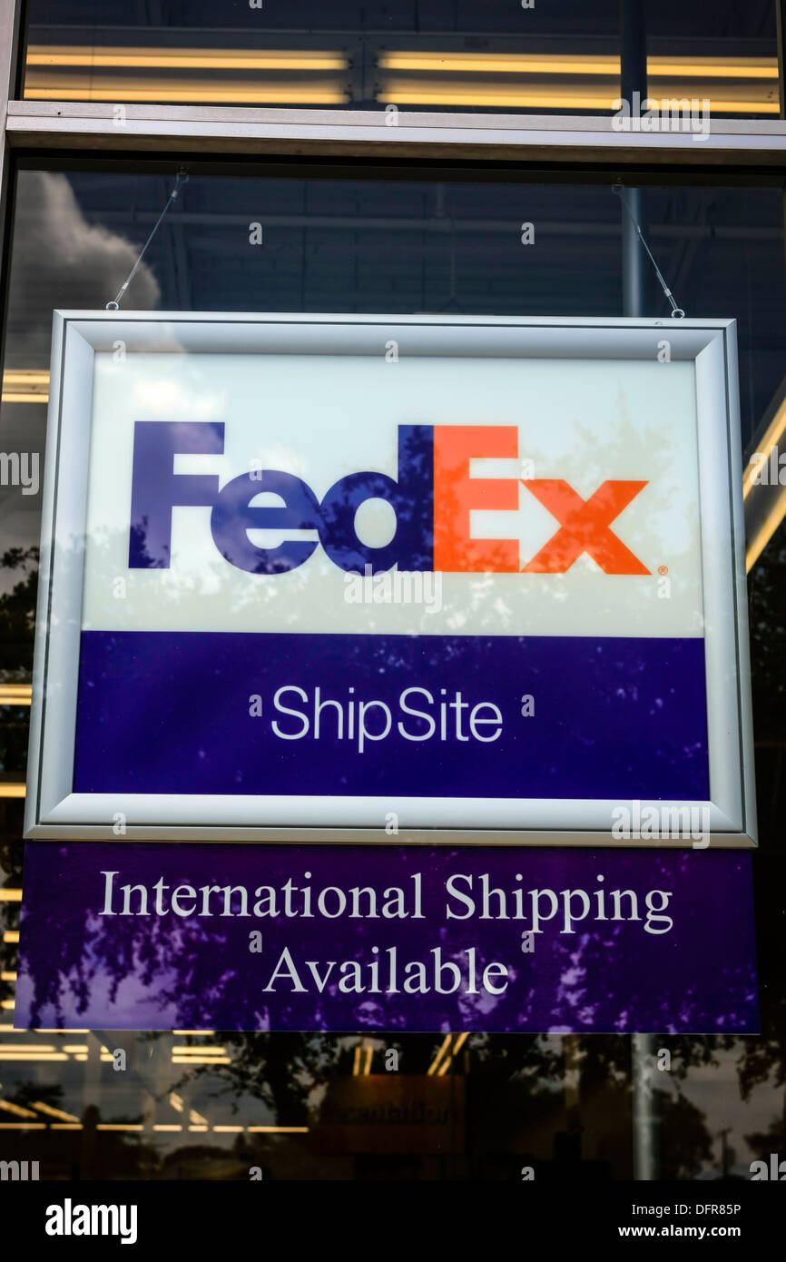 FedEx shipping sign hanging in the window of a store Stock Photo Alamy