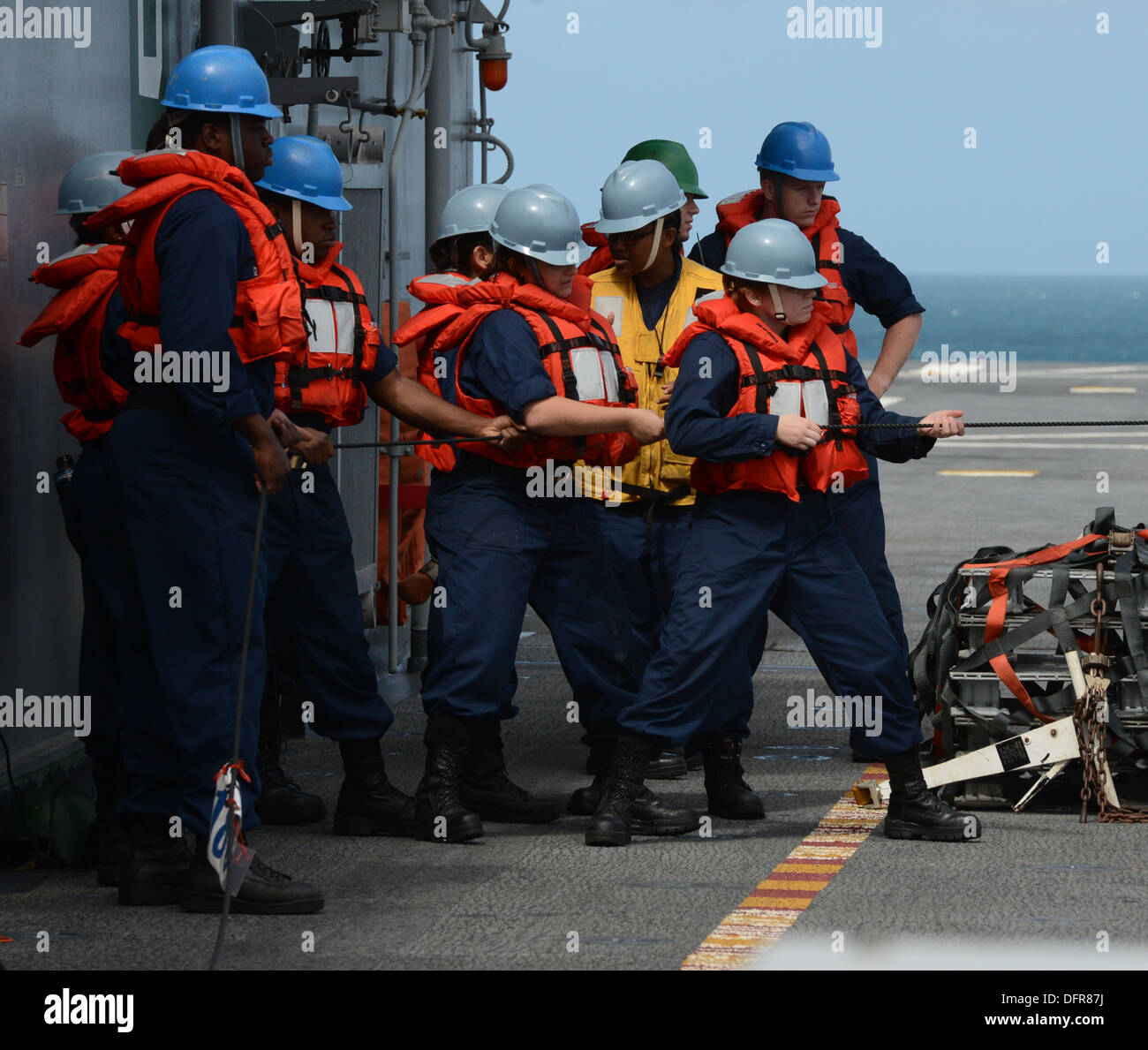 Sailors assigned to the ship's deck department heave lines during a replenishment at sea aboard the multipurpose amphibious assault ship USS Bataan (LHD 5) Sept. 29. Bataan Sailors and 22nd Marine Expeditionary Unit Marines are underway conducting routine Stock Photo