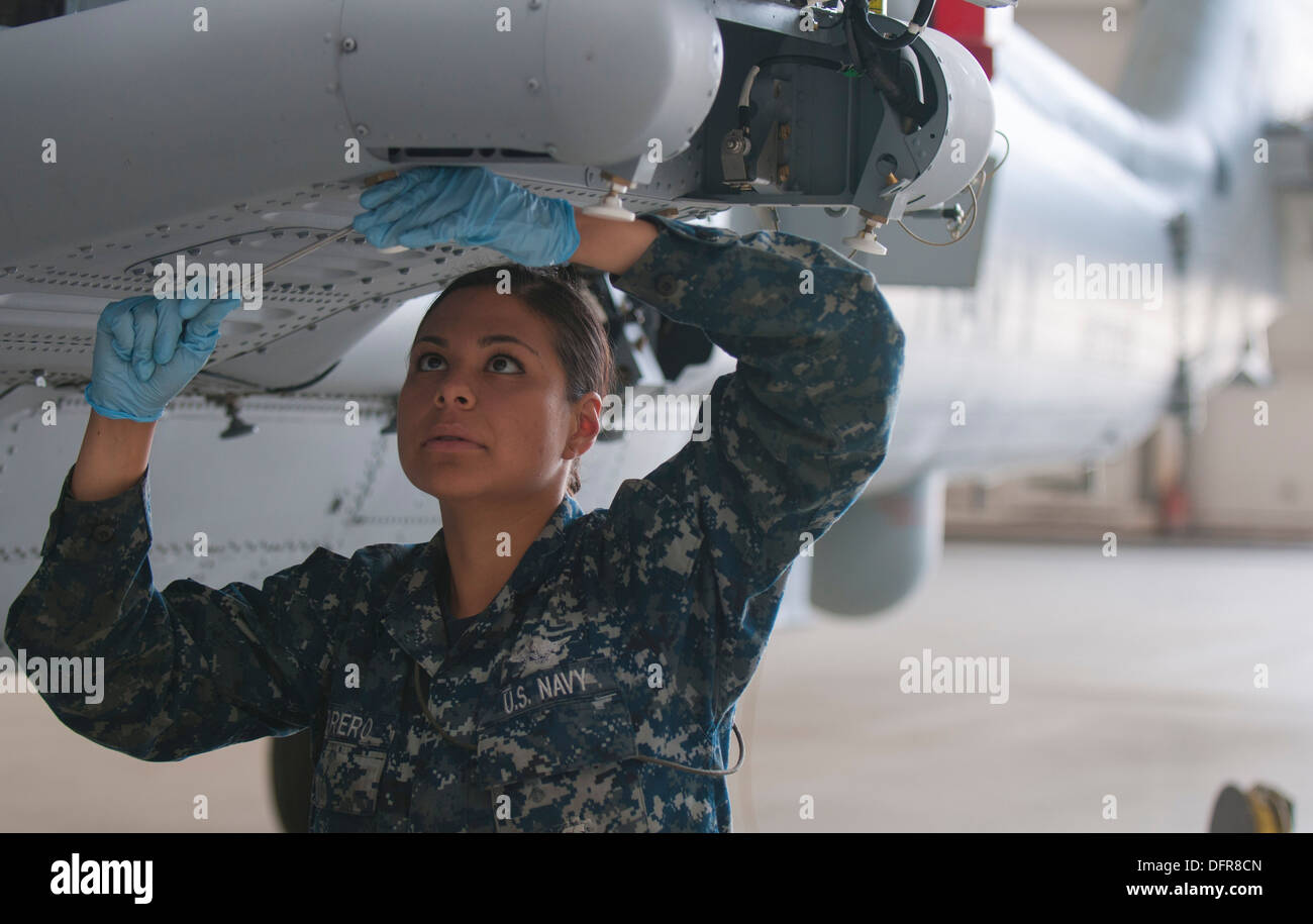 Aviation Ordnanceman Airman Ivonne Ferrero, assigned to the Helicopter Maritime Strike Squadron (HSM) 41, performs maintenance Stock Photo