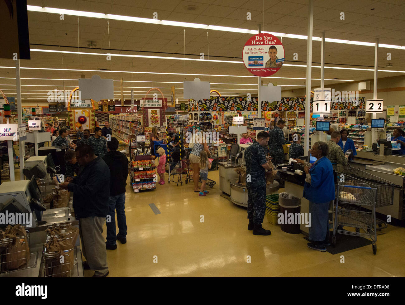 Sailors and their families check out groceries in the Naval Air Station North Island commissary before it temporarily closes during the government furlough. The Defense Commissary Agency, which manages 250 stores worldwide, is scheduled to close all U.S. Stock Photo