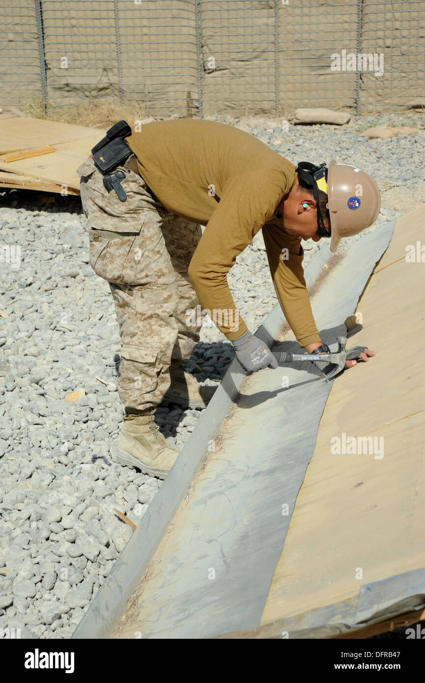 Kandahar Airfield, Afghanistan - US Navy Construction Electrician 2nd Class Dennis Cadatel, attached to Naval Mobile Construction Battalion (NMCB) 28, works on a demolition project, Oct. 2, 2013. NMCB 28 is based out of Barksdale Air Force Base, Shrevepor Stock Photo