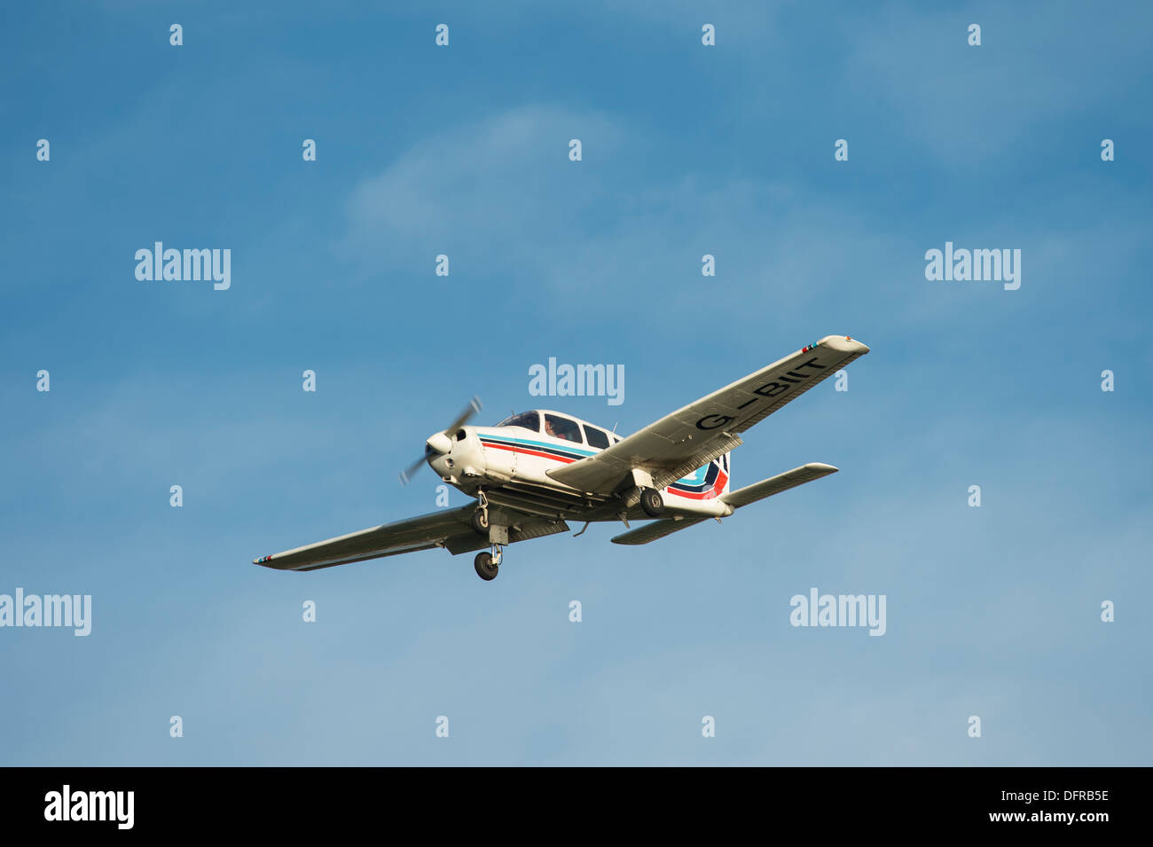 Light aircraft in Tayside Aviation colours flying overhead on a summer's day. Stock Photo