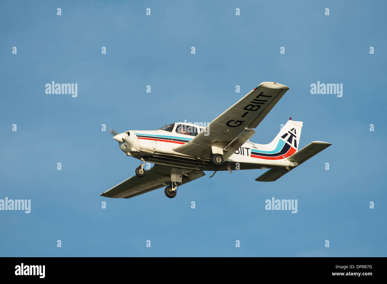 Light aircraft in Tayside Aviation colours flying overhead on a summer's day. Stock Photo