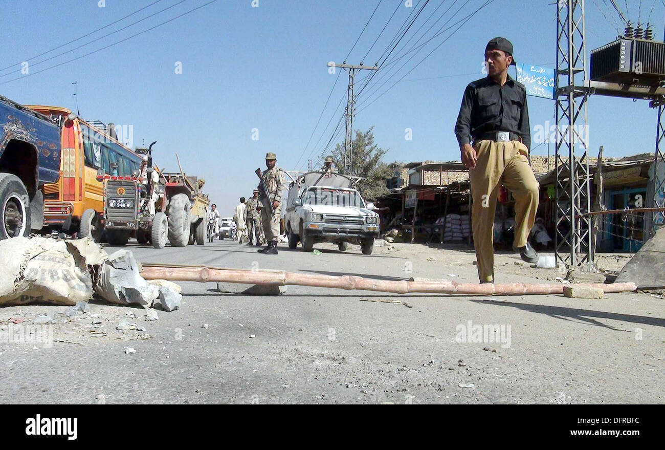 Security officials gather to measure extent of damages after hand grenade attack near a police station at Sariab Road of Quetta on Tuesday, October 08, 2013. A hand-grenade attack at Quetta's New Sariab police station on Tuesday wounded eight persons, including policemen, according to eye witnesses unknown motorcyclists hurled a hand grenade at the New Sariab police station situated on the outskirts of Quetta which exploded causing injuries to eight people. Stock Photo