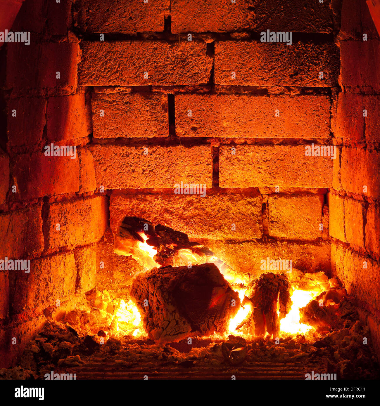 flames of fire in fireplace in evening time Stock Photo