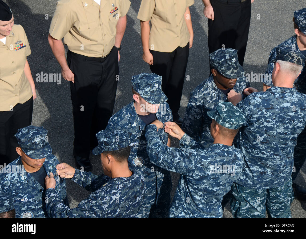 Sailors assigned to the submarine tender USS Frank Cable (AS 40) are pinned during an awards ceremony. Frank Cable, forward deployed to the island of Guam, conducts maintenance and support of submarines and surface vessels deployed in the U.S. 7th Fleet a Stock Photo