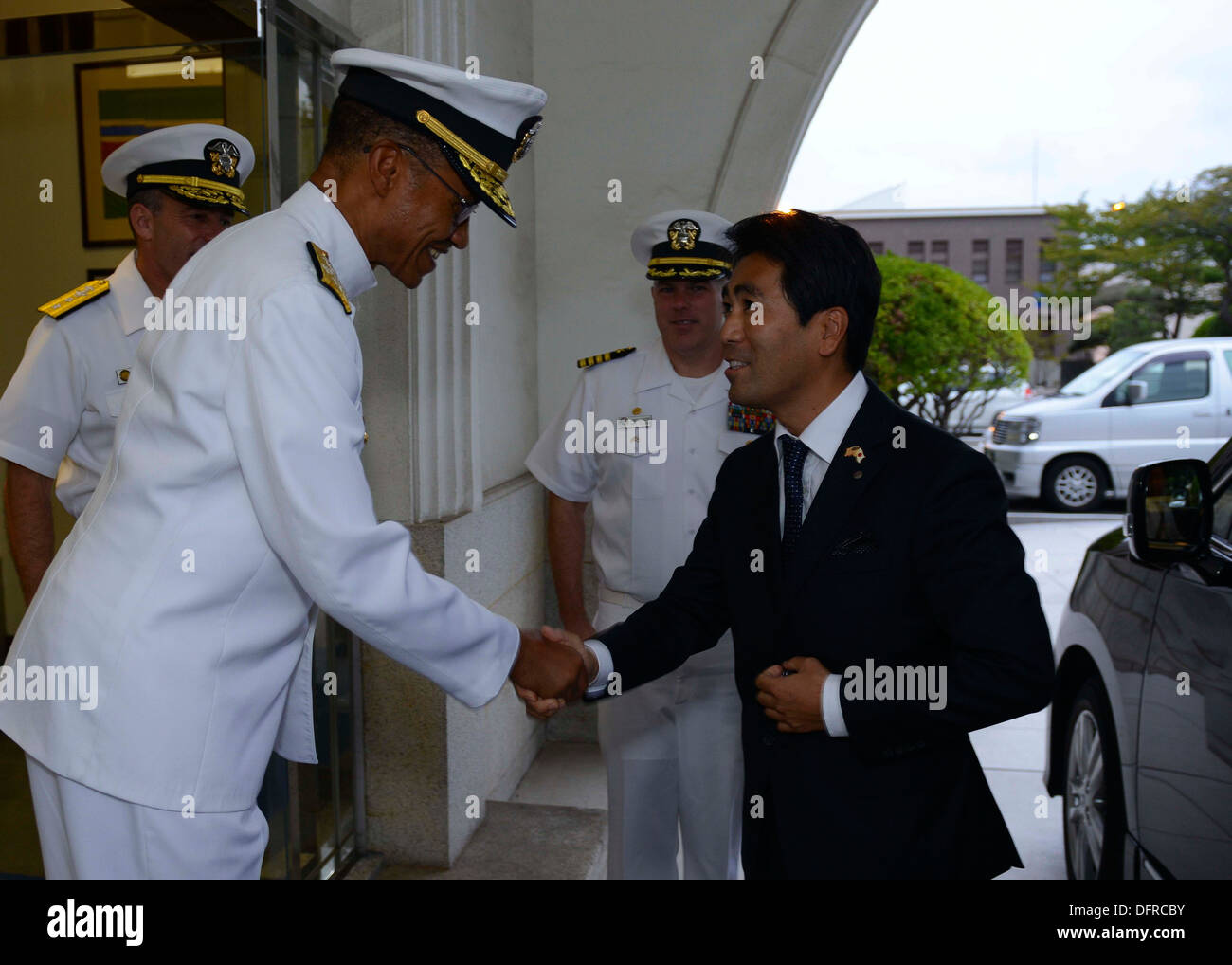 Adm. Cecil Haney, commander of U.S. Pacific Fleet, greets the mayor of Yokosuka, Yuto Yoshida. Haney met with Yoshida and other Stock Photo