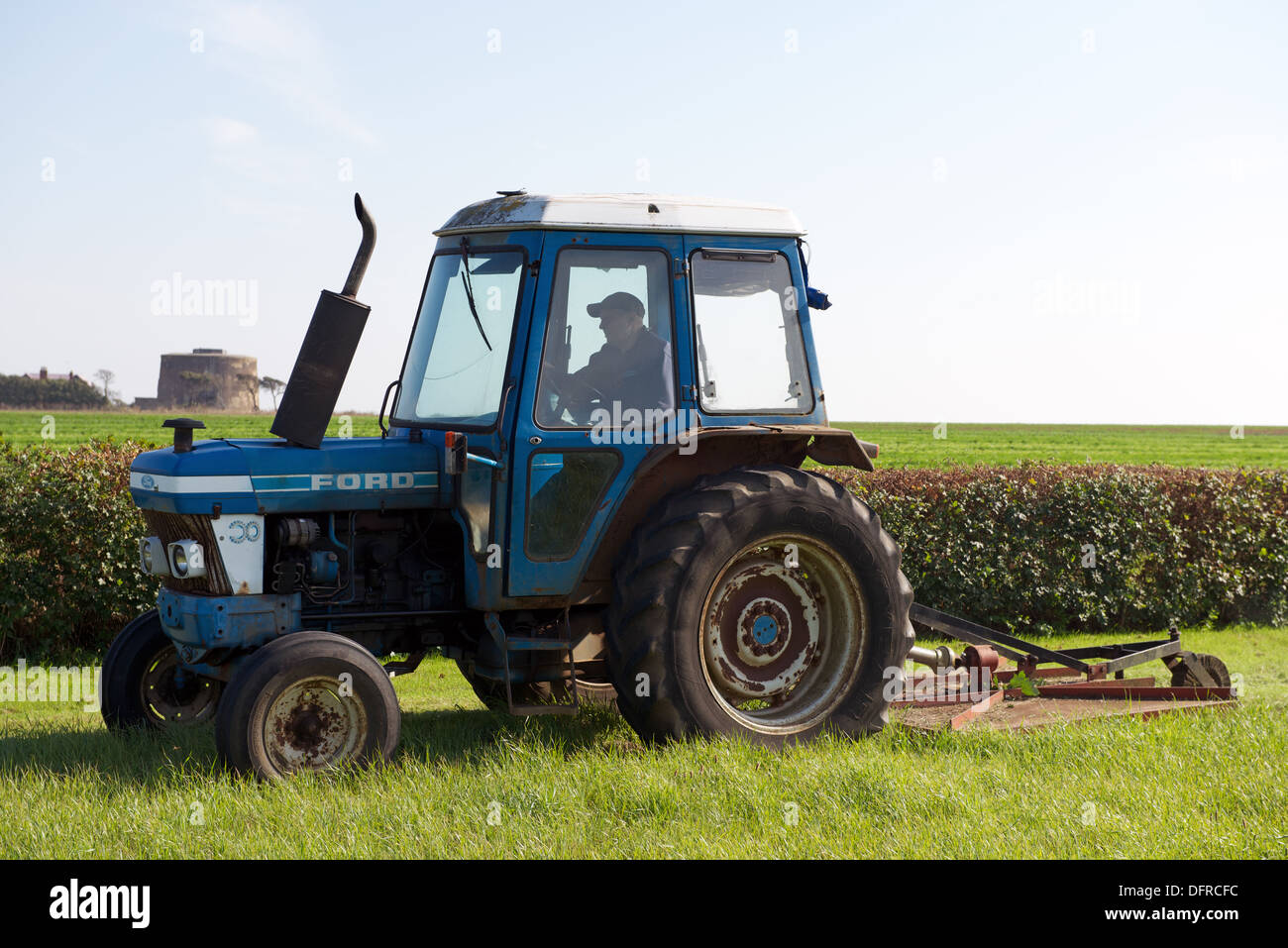 Farmer cutting grass meadow Stock Photo