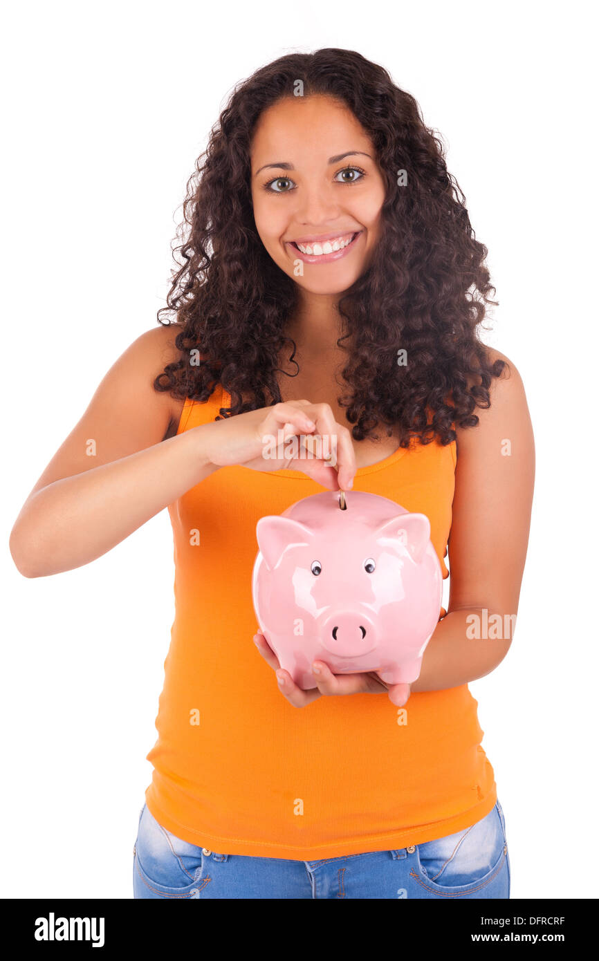 Young african american woman putting coin in piggy bank isolated Stock ...