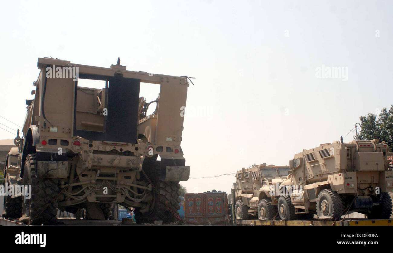 Mine-Resistant Ambush Protected (MRAP) armoured vehicles of the US-led Nato forces area seen loaded over trailers outside the Karachi port after they were brought from Afghanistan, in Karachi on Tuesday, October 08, 2013. The city port has witnesses an increase in shipments of military supplies before the planned withdrawal of US forces from Afghanistan next year. Stock Photo