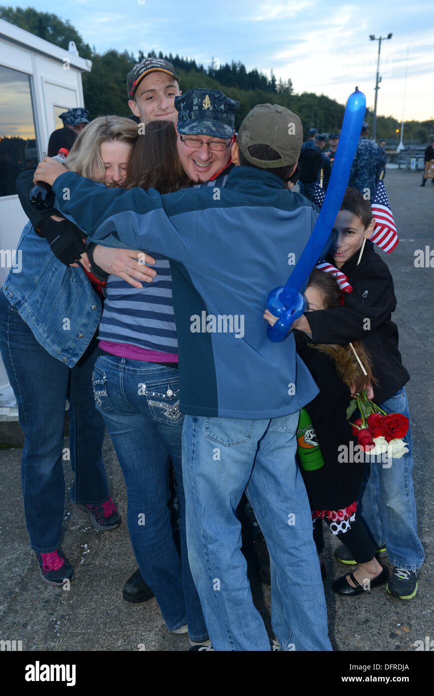Senior Chief Machinist's Mate Shane Hilson receives a group hug from his family after USS Nebraska (SSBN 739) Gold crew returned to Naval Base Kitsap-Bangor, Wash., following a 105-day strategic deterrent patrol. Stock Photo