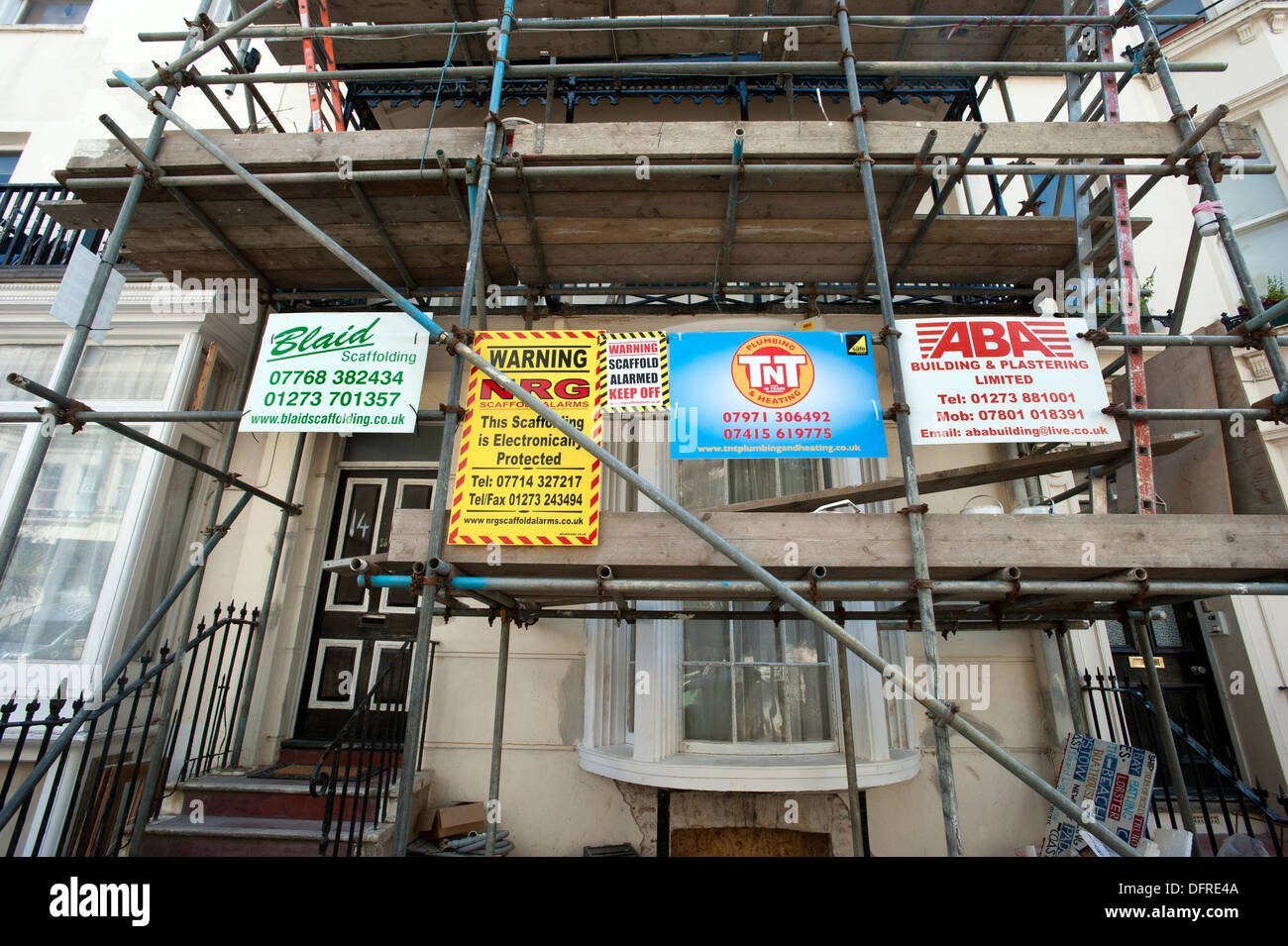Builders' advertising boards on scaffolding on an 1822 built Regency