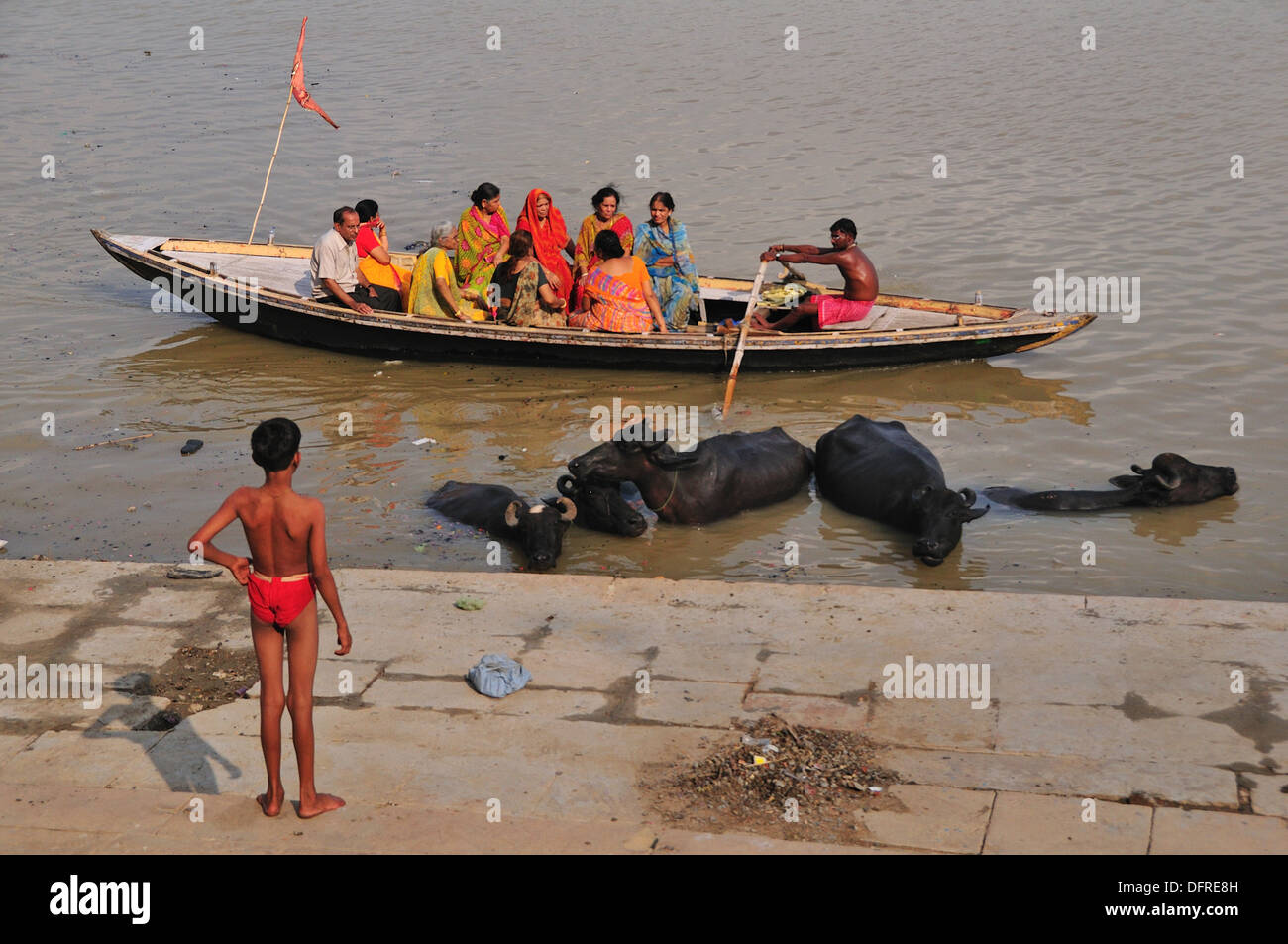 Pilgrims enjoying sight seeing boat trip by the ghat Stock Photo