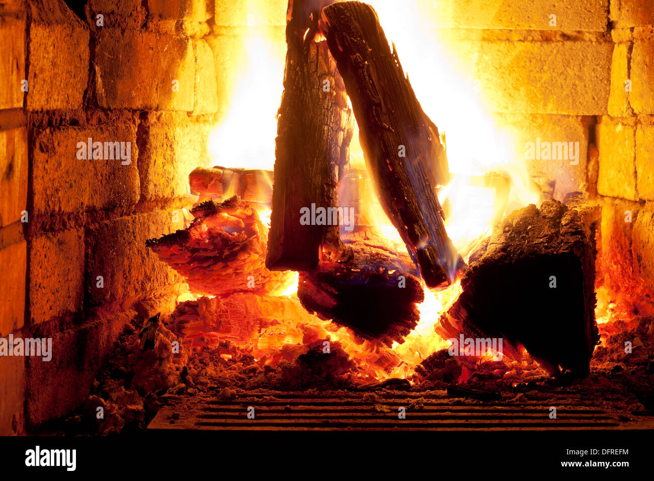 burning wood in fireplace in evening time Stock Photo