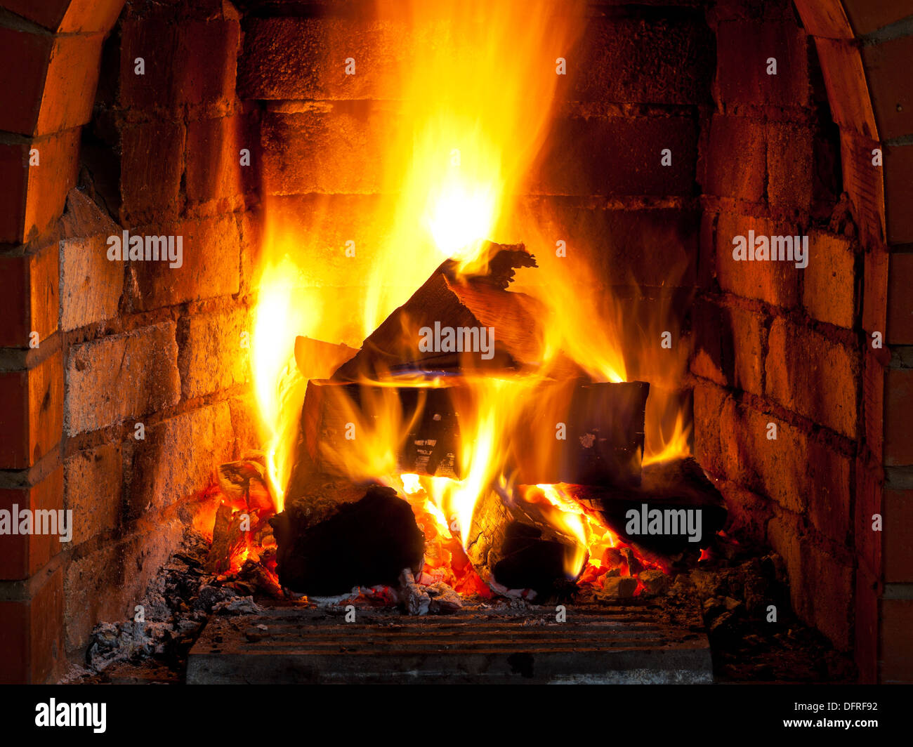 fire in fireplace in evening time Stock Photo
