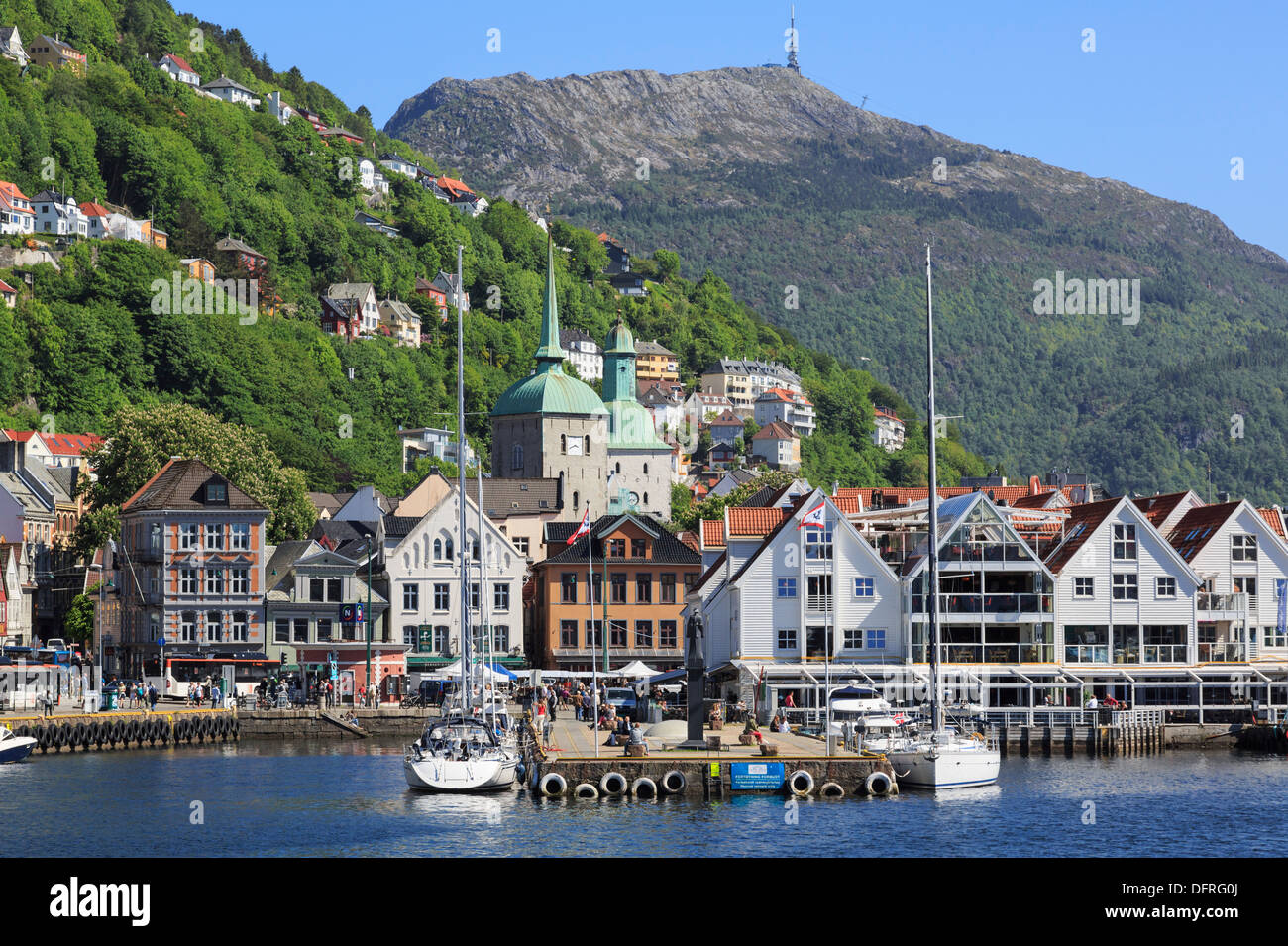 View across Vågen harbour to Mount Ulriken above historic Fiskerestaurant on Torget in city of Bergen, Hordaland, Norway Stock Photo